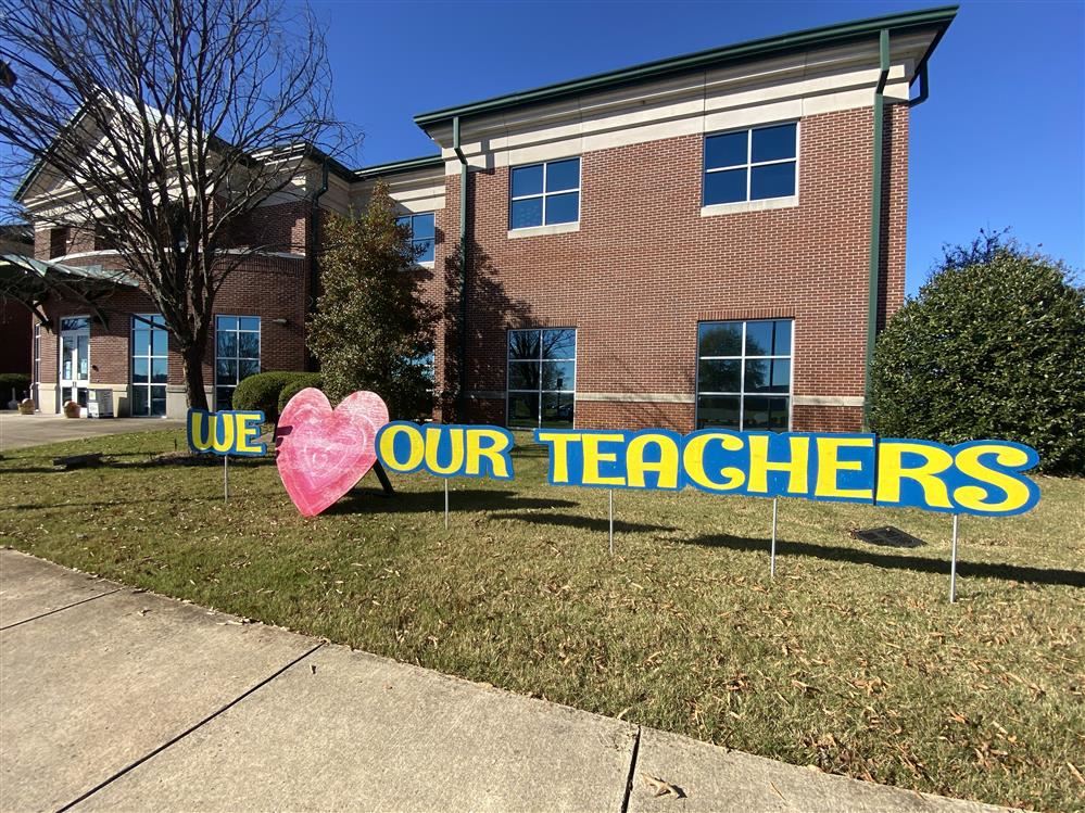 outside view of Central Office with a We love our teachers banner